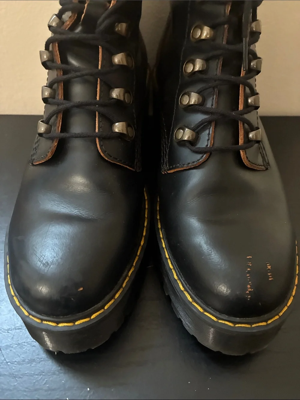 Dr. Martens Leona platform boots featuring a black smooth leather size 9